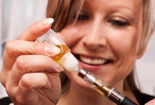 Girl Loading a Vaporizer pen